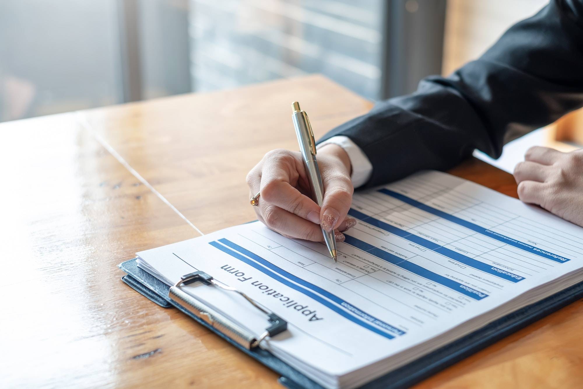 Women fill out the application form to apply for job.